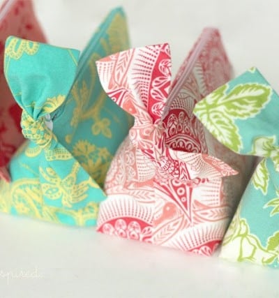 four zippered pouches lined up with bows