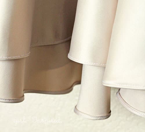 bottom hem of a beige satin dress with rolled hem