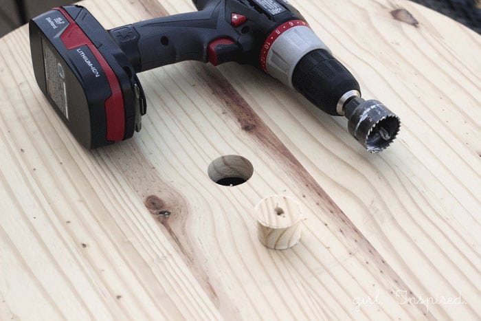 drill on unfinished wooden round with hole drilled out in center