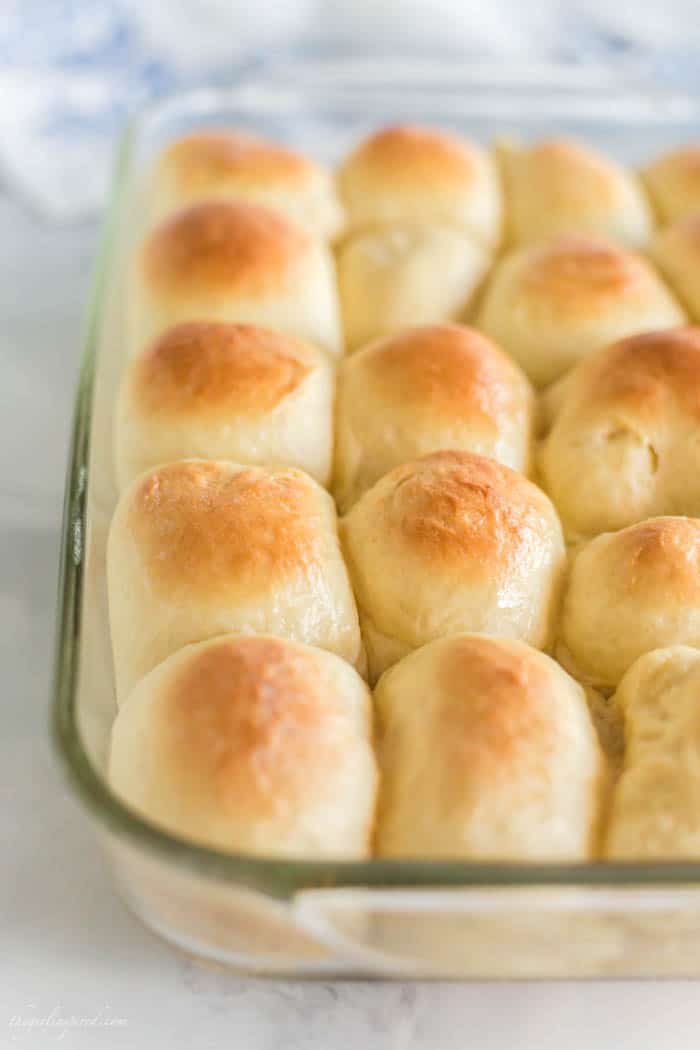 clear glass baking dish with dinner rolls