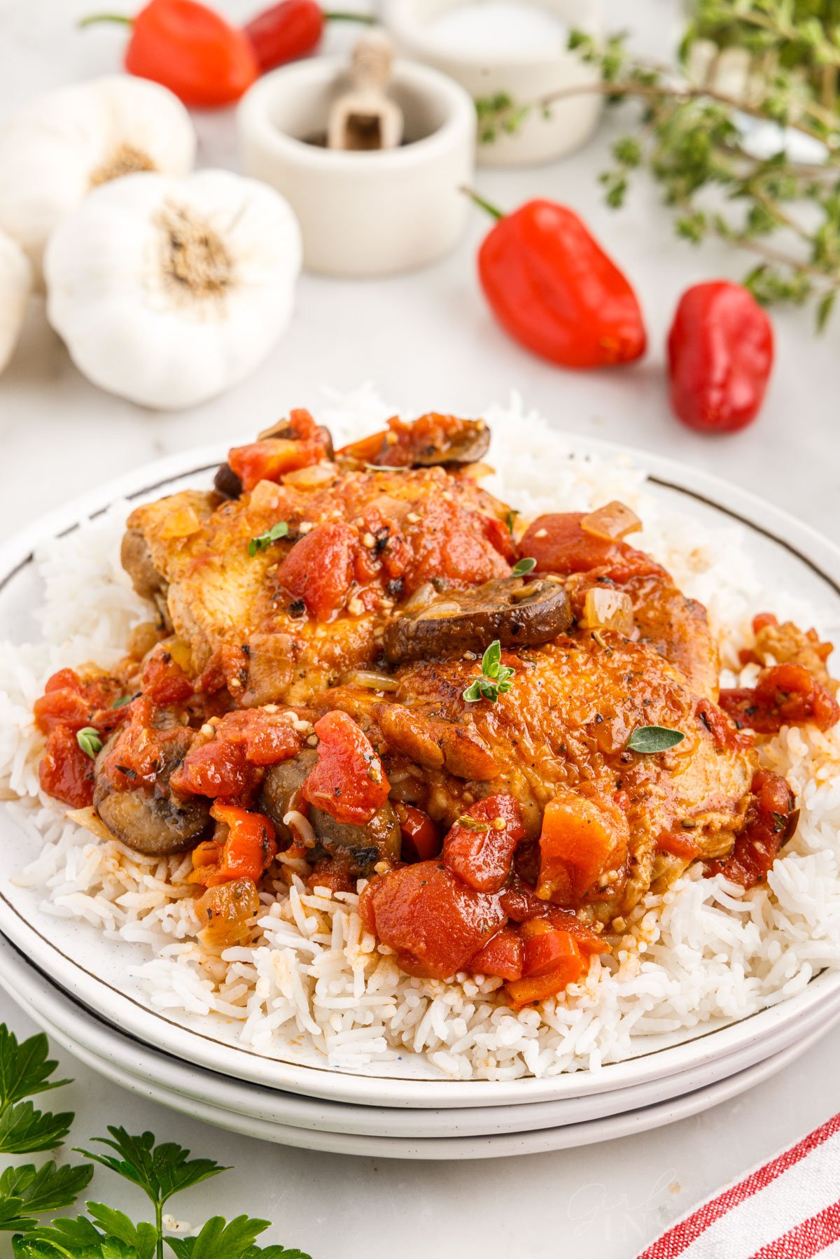 Plate piled with rice and chicken cacciatore recipe over the rice.