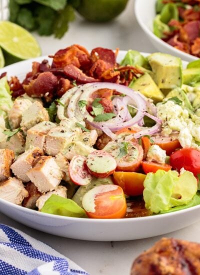 A chopped chicken salad in a large white bowl tossed in cilantro lime dressing.