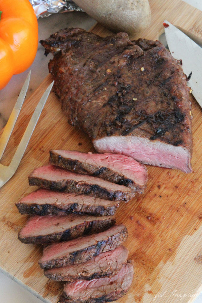 sliced steak on wooden cutting board