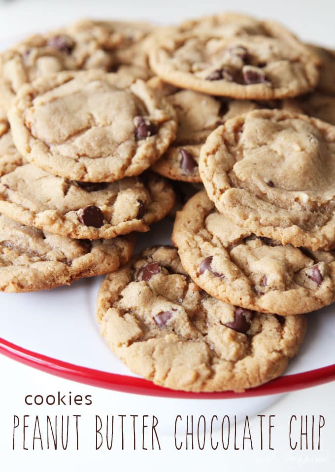 pile of peanut butter chocolate chip cookies on white cake stand with red rim and text overlay