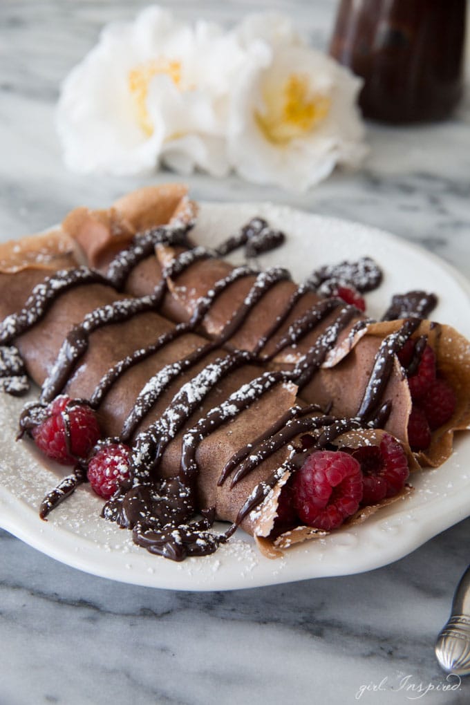 Chocolate Raspberry Crepes - These indulgent crepes are made with a chocolate batter and filled with fresh raspberries and doused with rich, chocolate ganache. YUM!