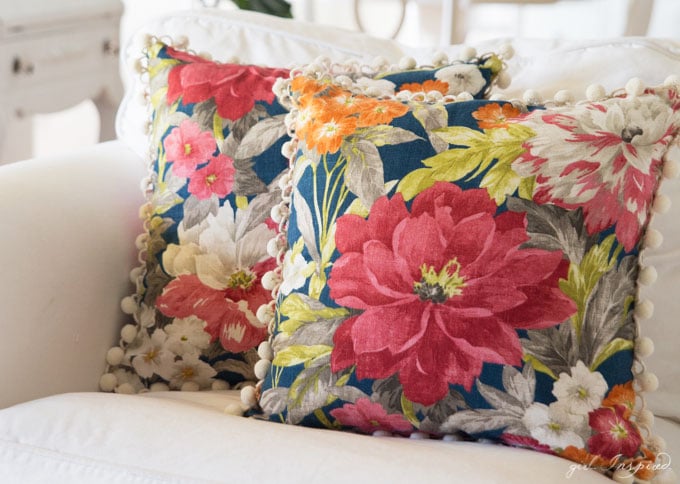two blue floral pillows on white couch