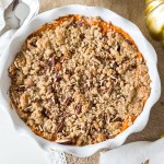 overhead of mashed holiday yams with a brown sugar and pecan topping baked over the top.