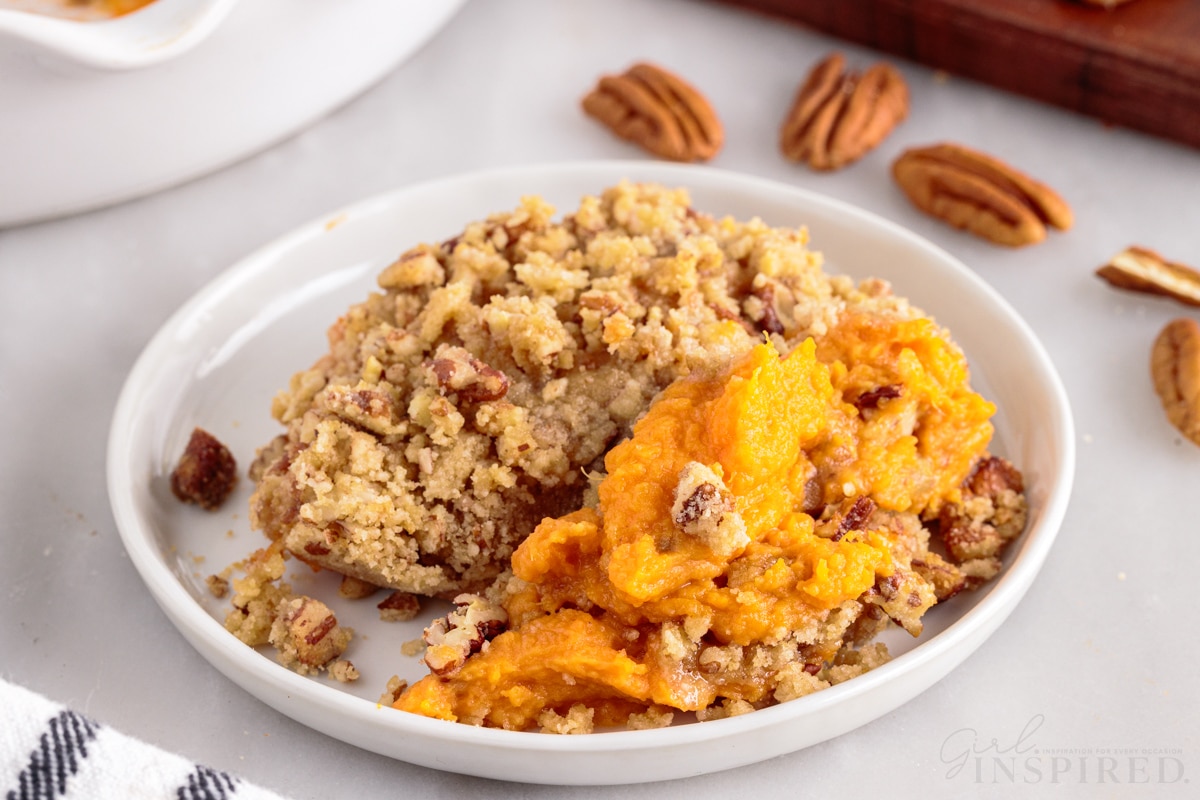 sweet potatoes and streusel topping dished out on white plate