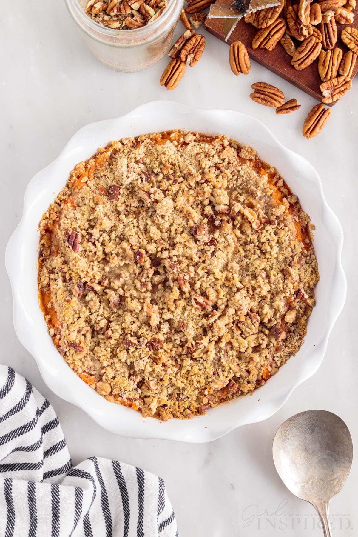 streusel topped sweet potatoes in white pie plate. 