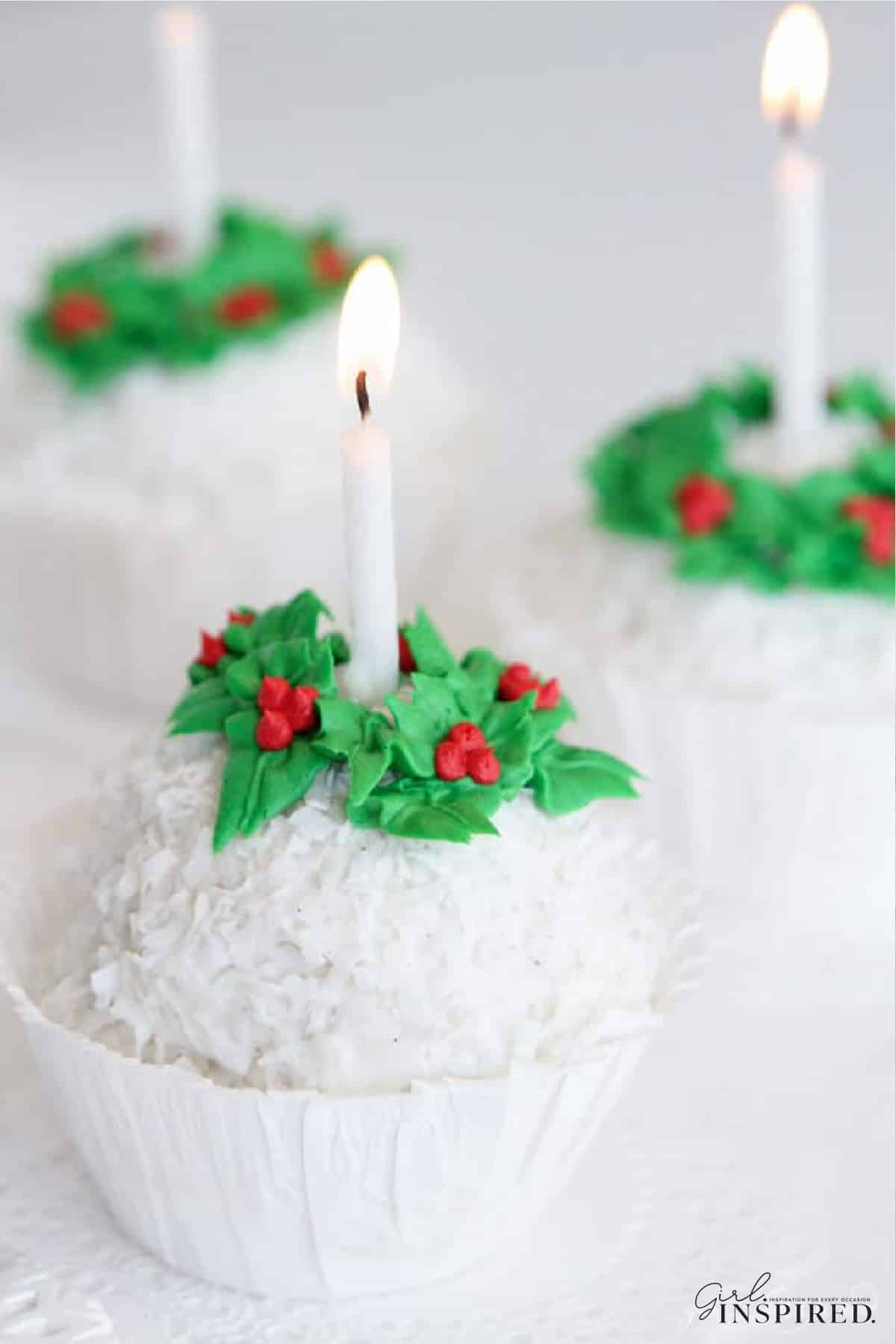 Three cups of snowball ice cream with lit candles.