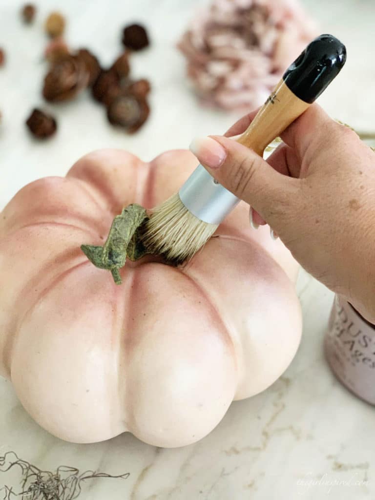 Use Antiqueing wax and dust of ages to give plastic craft pumpkins a weathered look