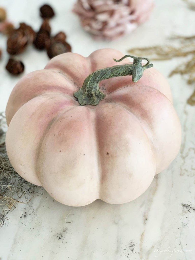 Use Antiqueing wax and dust of ages to give plastic craft pumpkins a weathered look