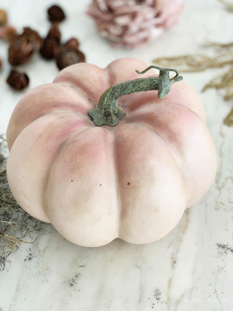 Use Antiqueing wax and dust of ages to give plastic craft pumpkins a weathered look