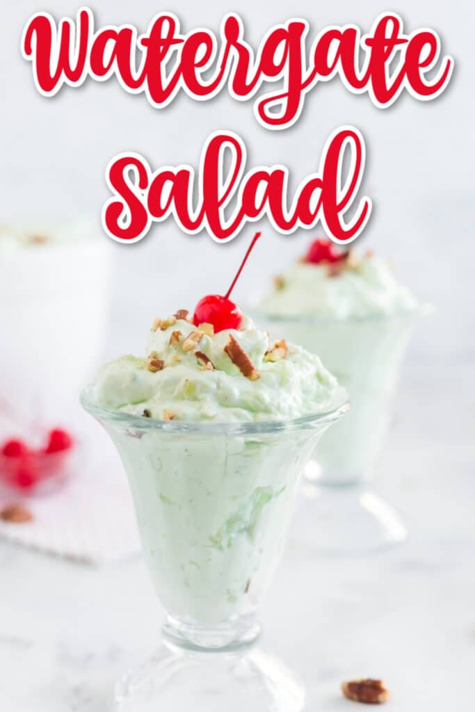 Watergate Salad in glass ice cream dishes with three maraschino cherries and pecans on top with text overlay