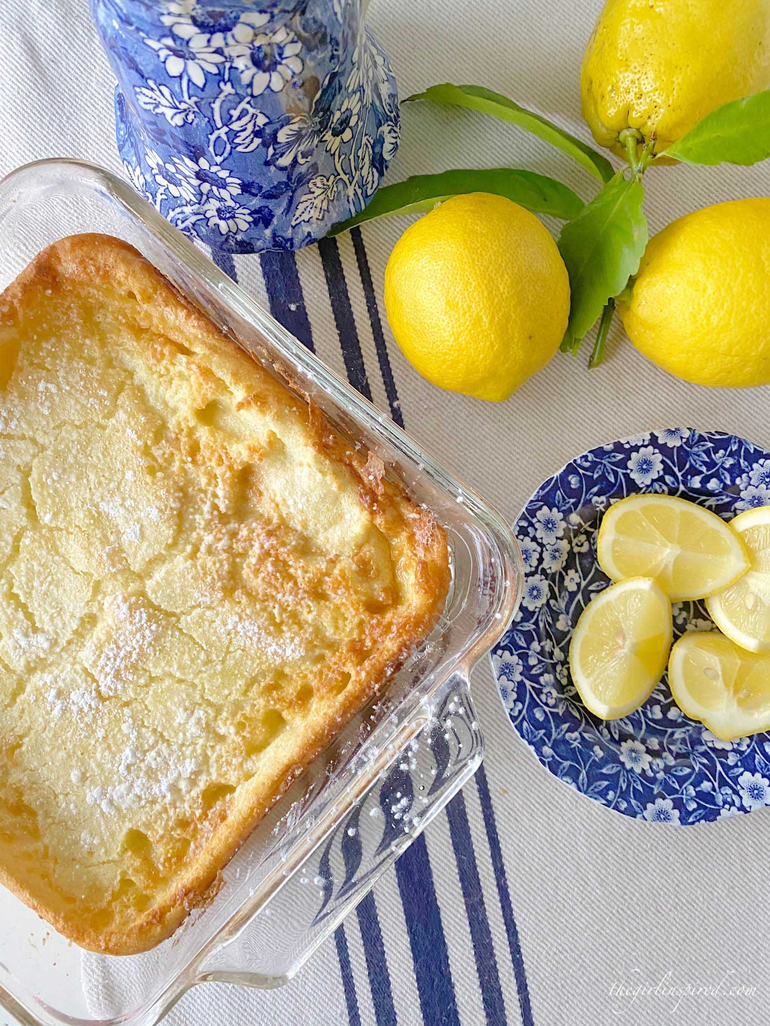 German pancake, lemons, lemon slices and blue plate