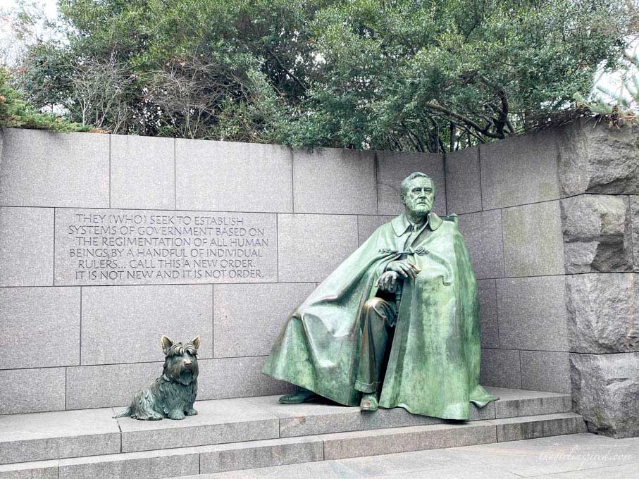 large iron sculpture of Franklin Roosevelt and his dog on stone steps