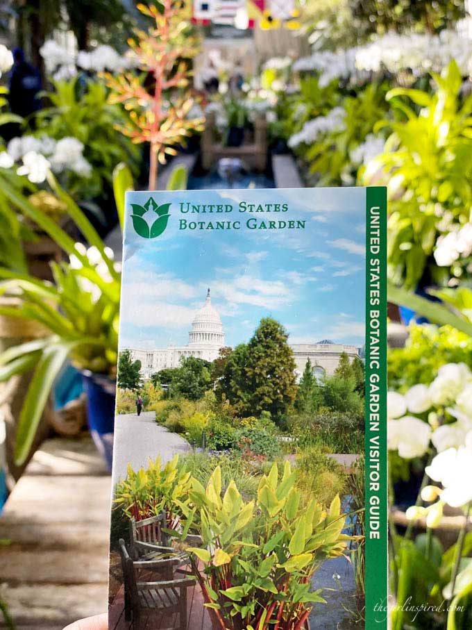 National Botanic Garden brochure with white, green, and orange flowers in the background.