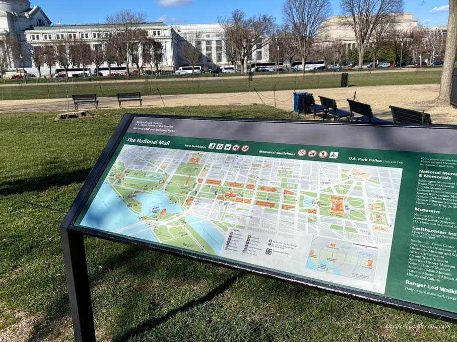 close up of park map with grass and museum buildings in the background