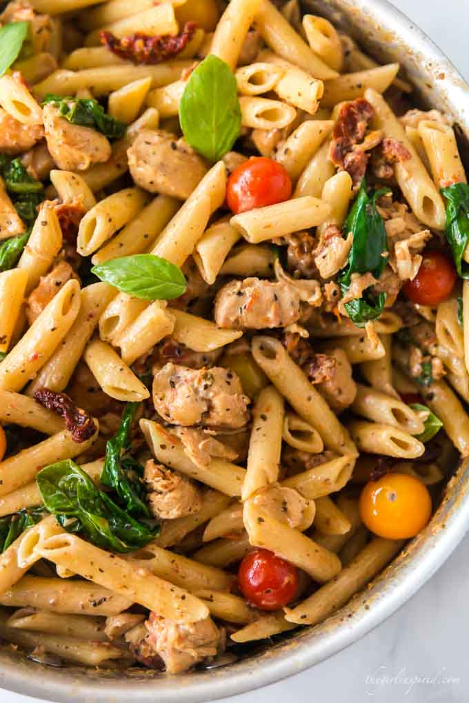 penne pasta with sun-dried tomatoes, chicken, and spinach