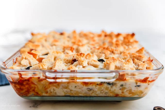 Glass casserole dish with tuna casserole and toasted breadcrumbs