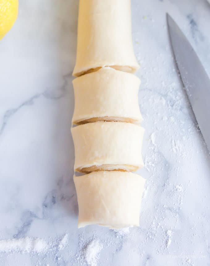 slices of rolled dough and knife on counter