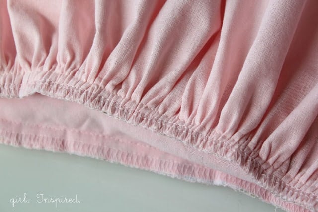 closeup of finished gathering stitch on pink fabric
