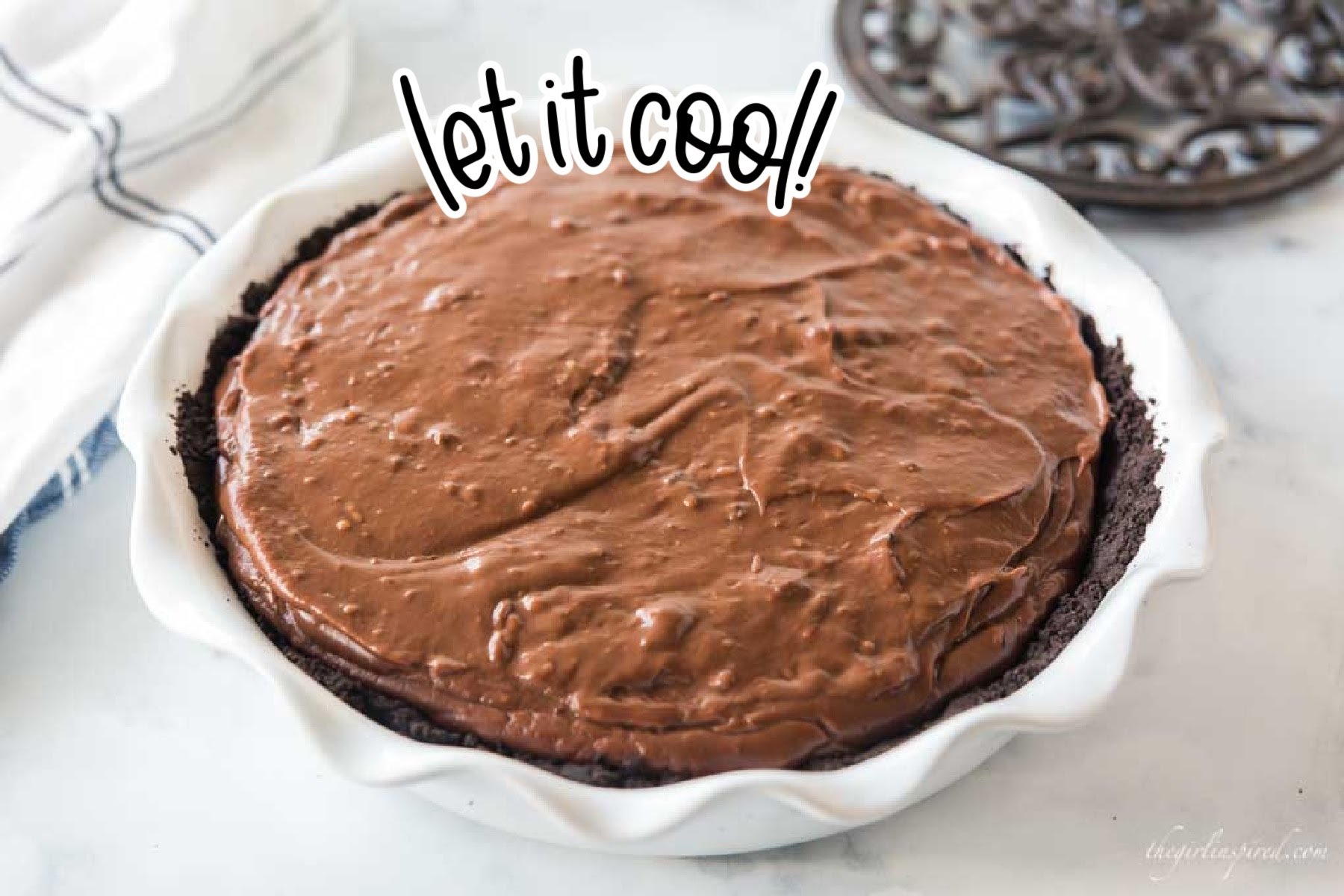 Filled chocolate cream pie in pie dish with text "let it cool."