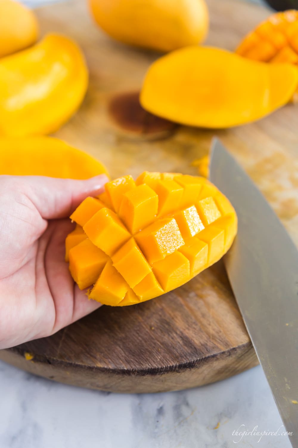 Half of a mango inverted so that chunks are popped outward.