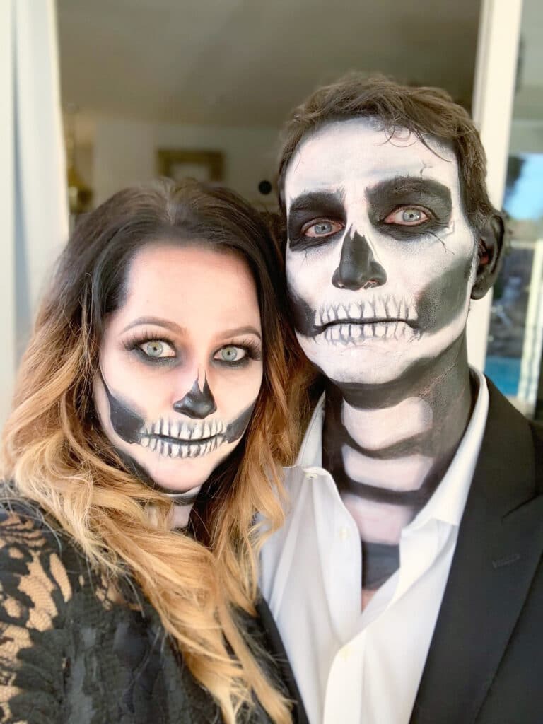 head shot of couple with skeleton face makeup