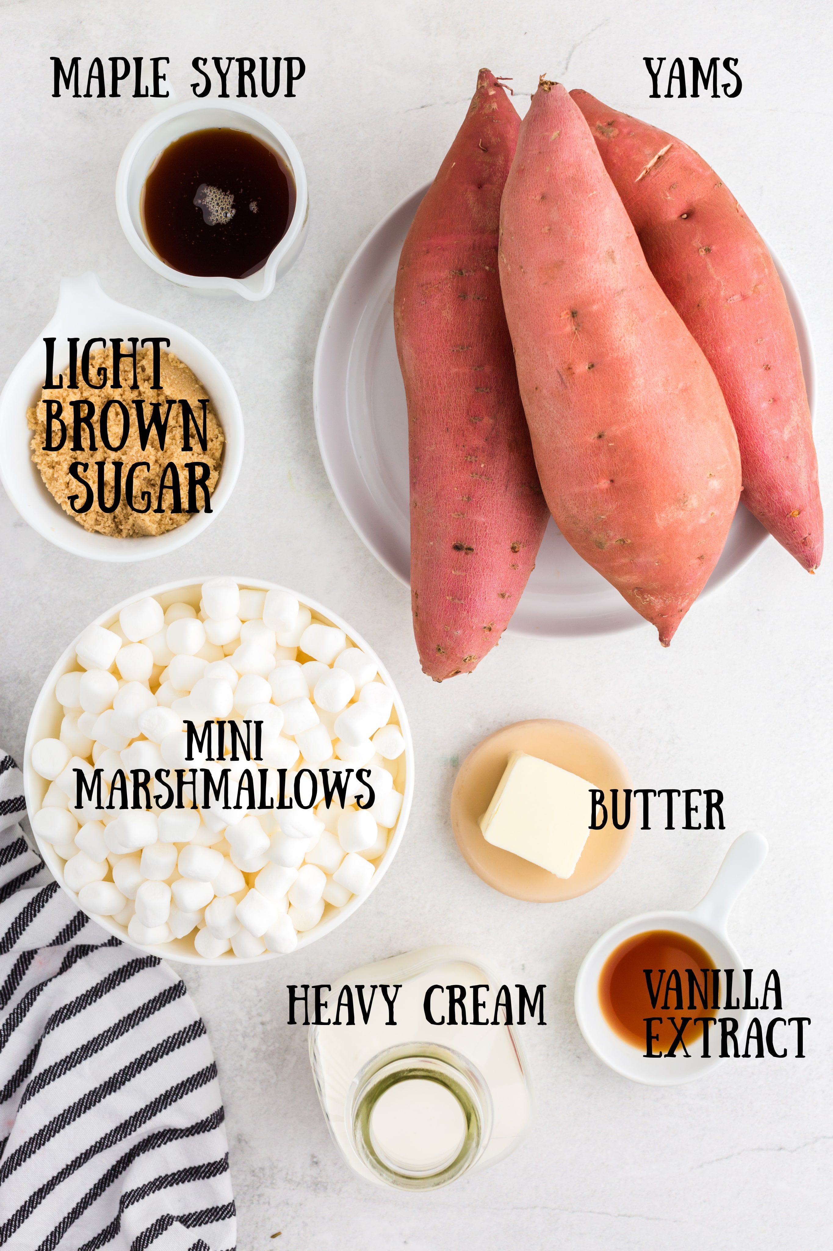 ingredients for candied yams including maple syrup, brown sugar, yams on white plate, mini marshmallows, a pat of butter, heavy cream in jar, and vanilla extract with text overlay
