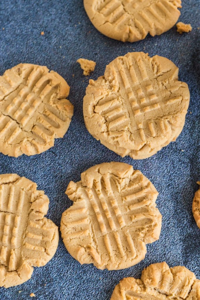 overhead view of peanut butter cookies on blue background
