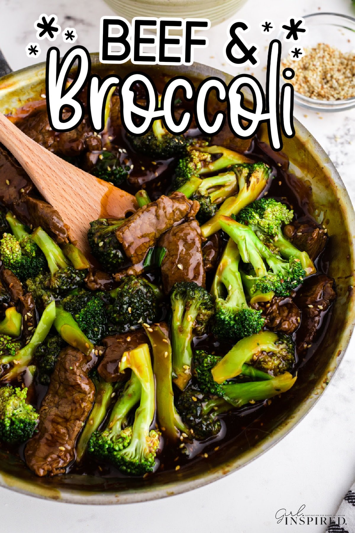 Panda Express beef and broccoli in skillet with wooden spatula lifting a scoop, with text overlay.