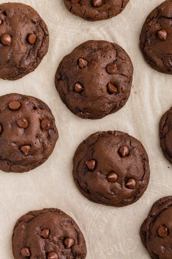 overhead photo of double chocolate chip cookies on parchment paper