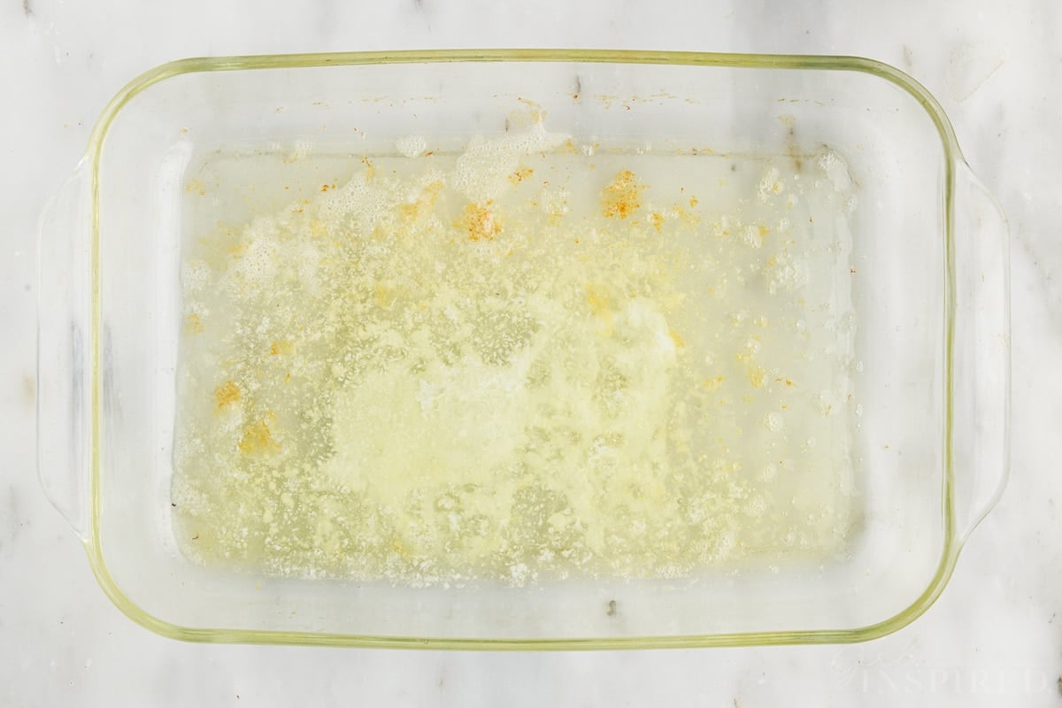 Melted butter in German pancake baking dish.