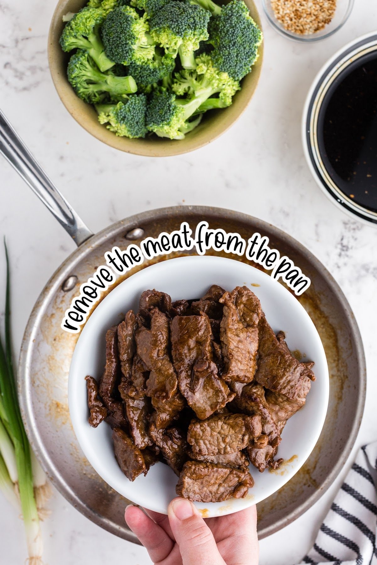 Seared beef for Panda Express beef and broccoli on plate held over saute pan, with text "remove the meat from the pan."