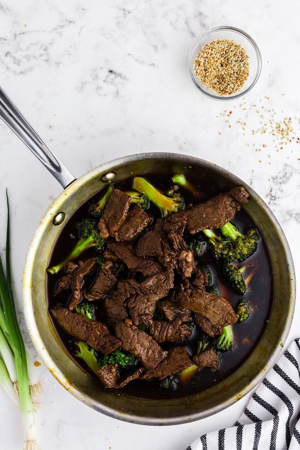 Seared beef added into skillet with Panda Express beef and broccoli.