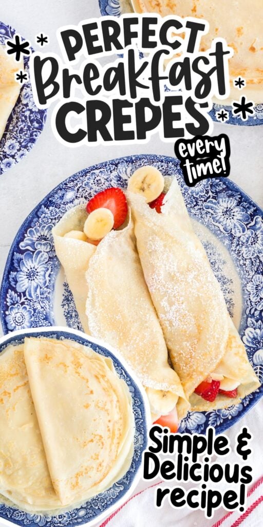 Two rolled breakfast crepes stuffed with bananas and strawberries dusted with powdered sugar.