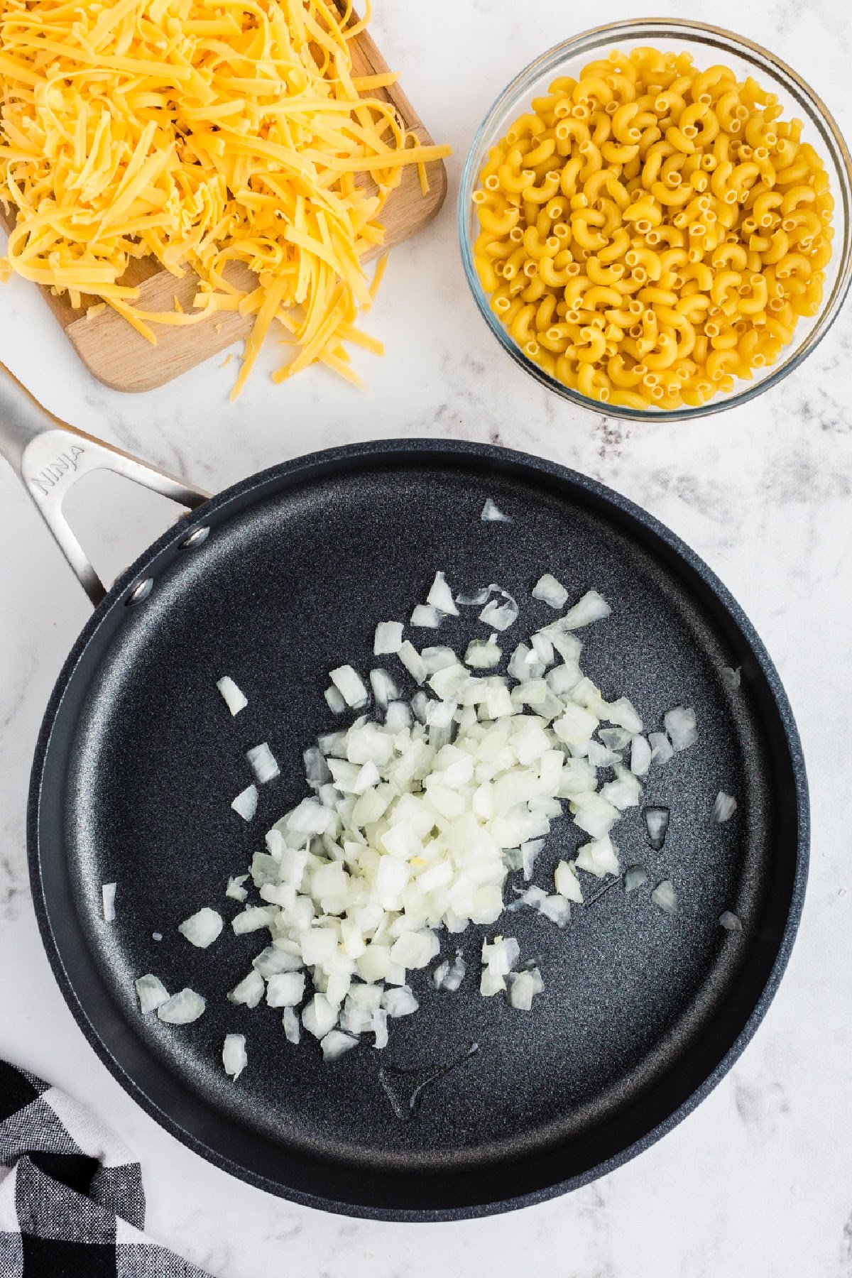 Diced onions in skillet with oil.