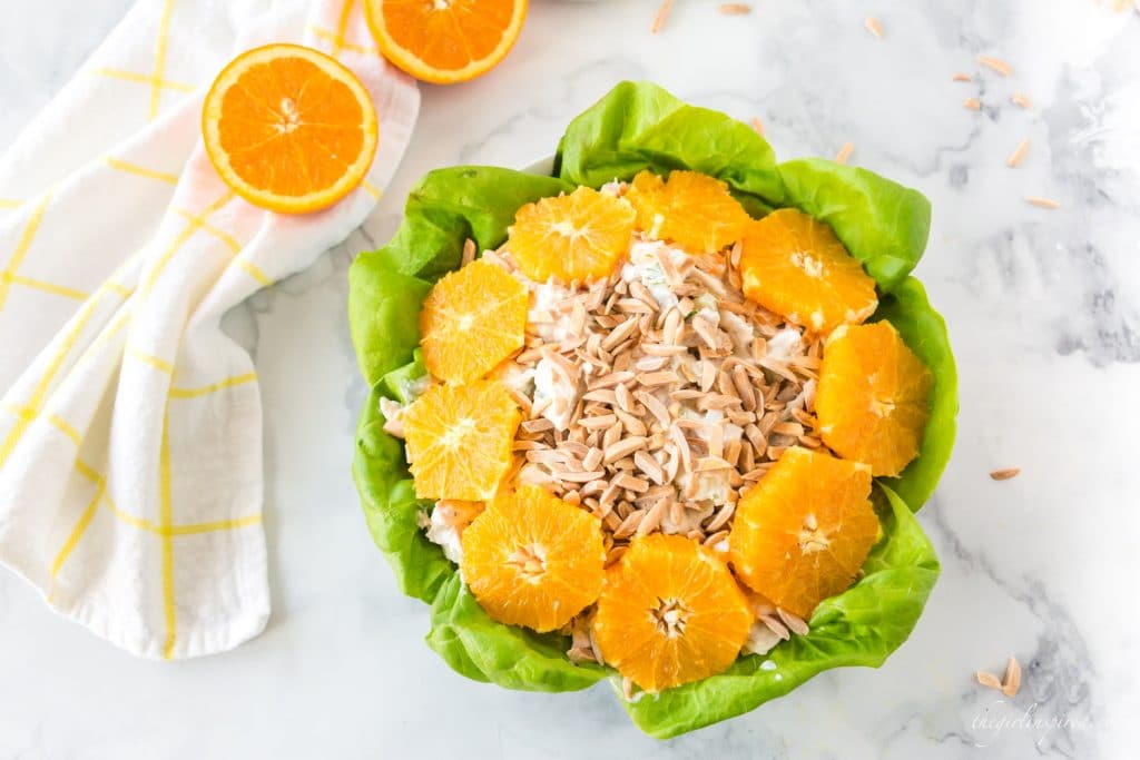 prepared chicken salad topped with almonds and a circle of orange slices
