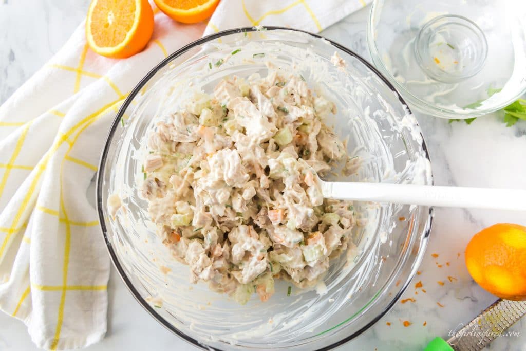 spatula and stirred chicken salad in glass bowl