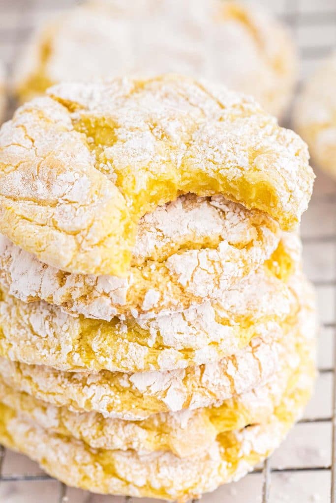 close up of stacked lemon Cool Whip cookies with bite taken out of top cookie