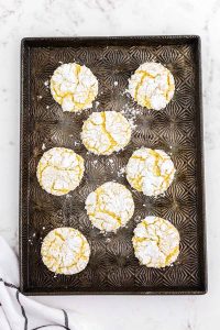 baked lemon cool whip cookies with crackled tops on cookie sheet