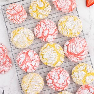 overhead of pink and yellow crinkle cookies on cookie sheet