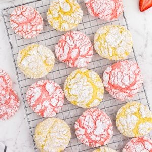 overhead of pink and yellow crinkle cookies on cookie sheet