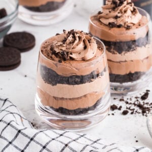 Layers of chocolate cookies, mousse, and Bailey's chocolate cheesecake in glasses.