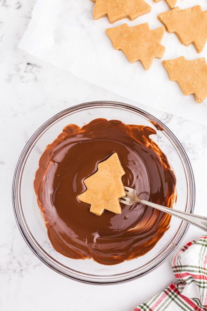 peanut butter tree held over bowl of melted chocolate