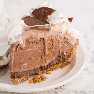 a slice of peanut butter chocolate ice cream pie on a white cake plate