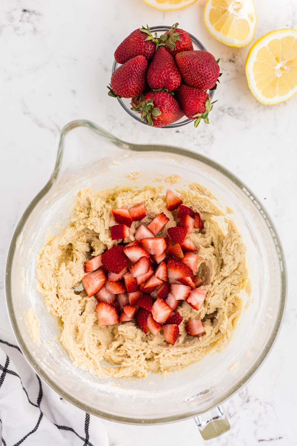 Mixing bowl with cake batter and strawberries