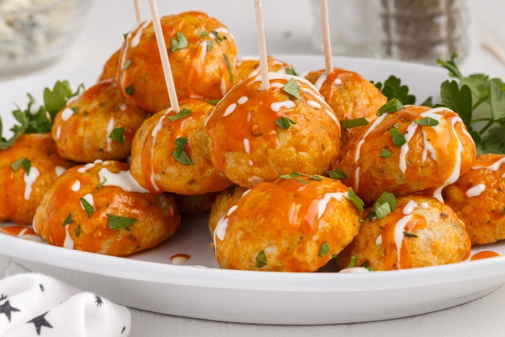 buffalo chicken meatball appetizers with toothpicks in them