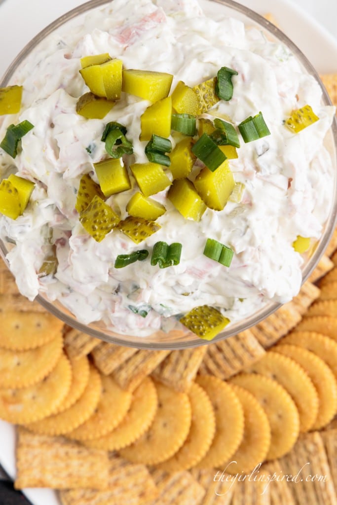 top view of dill pickle dip on serving tray with crackers